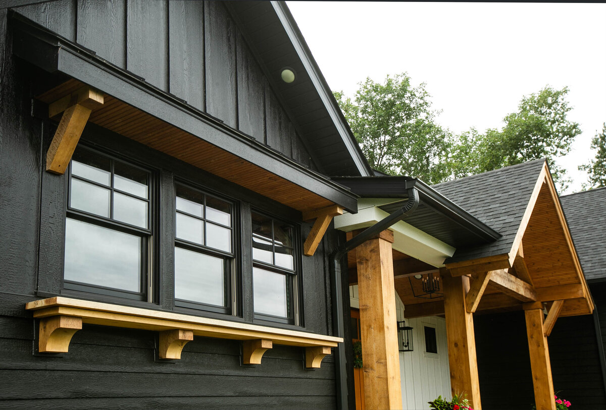 Exterior view of custom home in Otsego, Minnesota with modern wood details and front porch built by Cornerstone Custom Builds