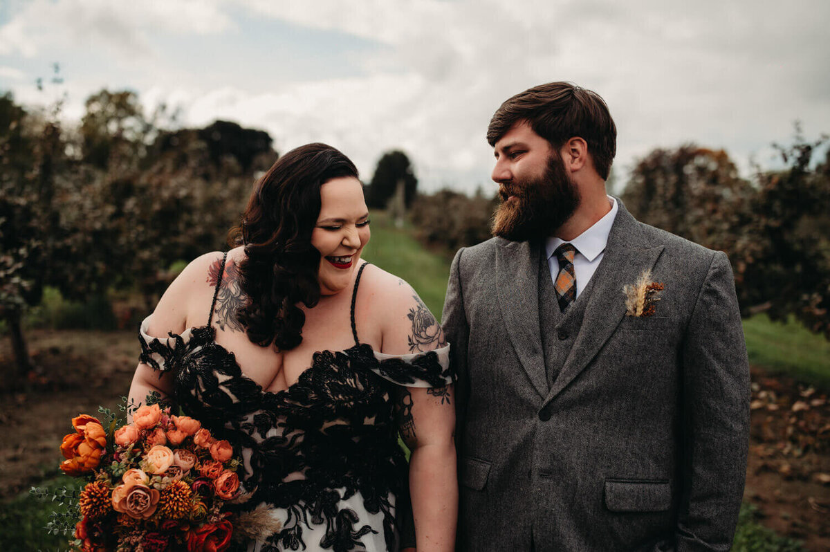 Couple laughs at Fall wedding with lord of rings theme