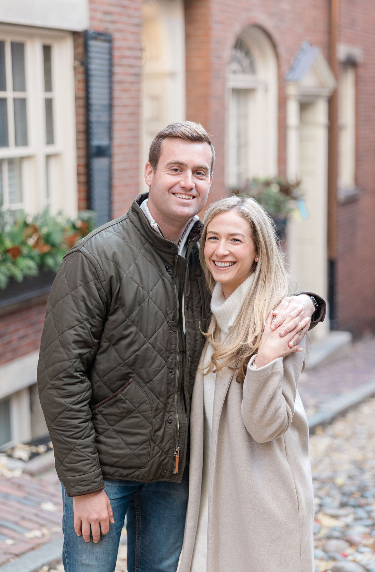 Engaged couple embrace on Beacon Hill
