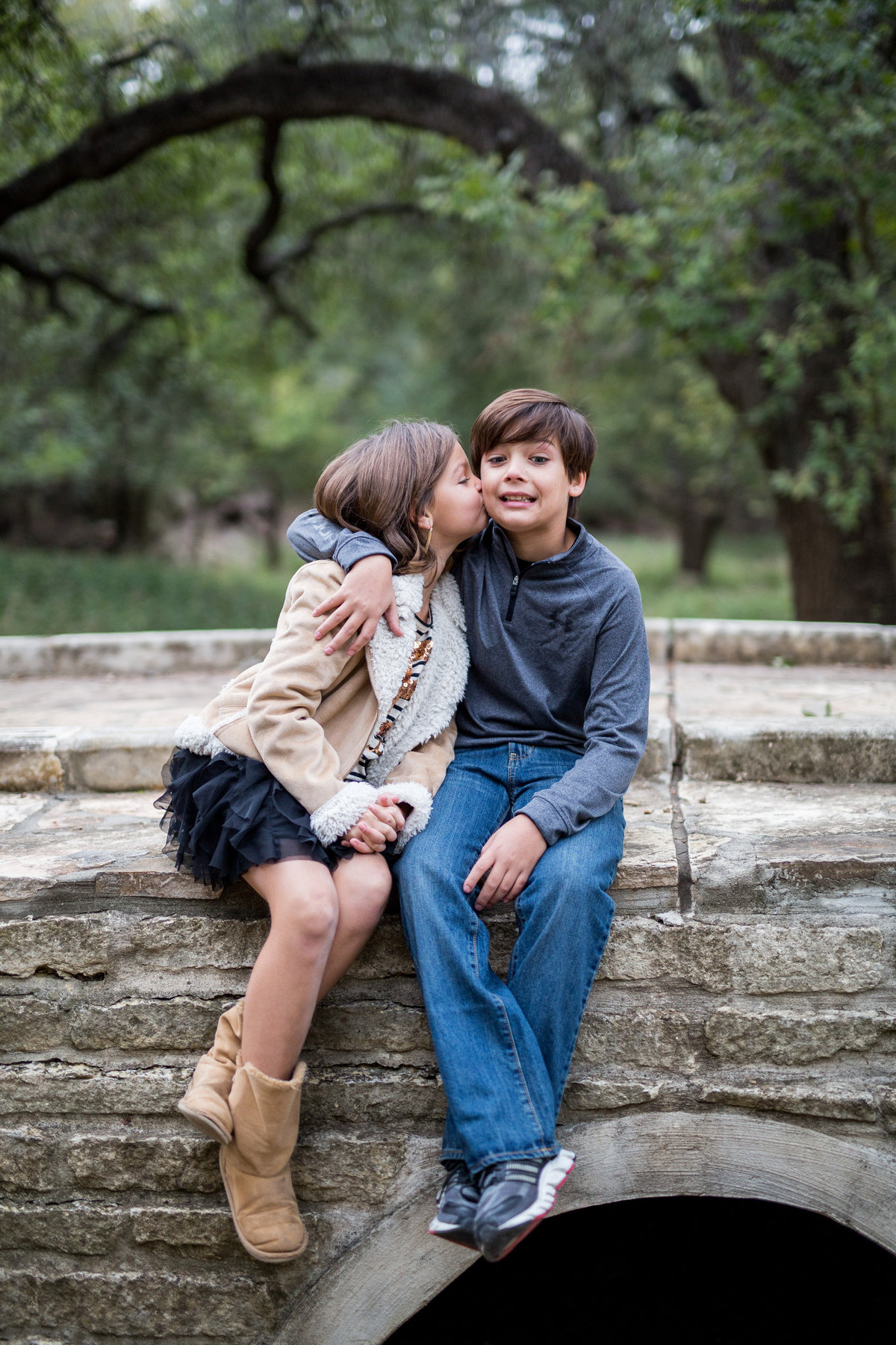 picture of sister kissing her brother on the cheek by San Antonio photographer Expose The Heart
