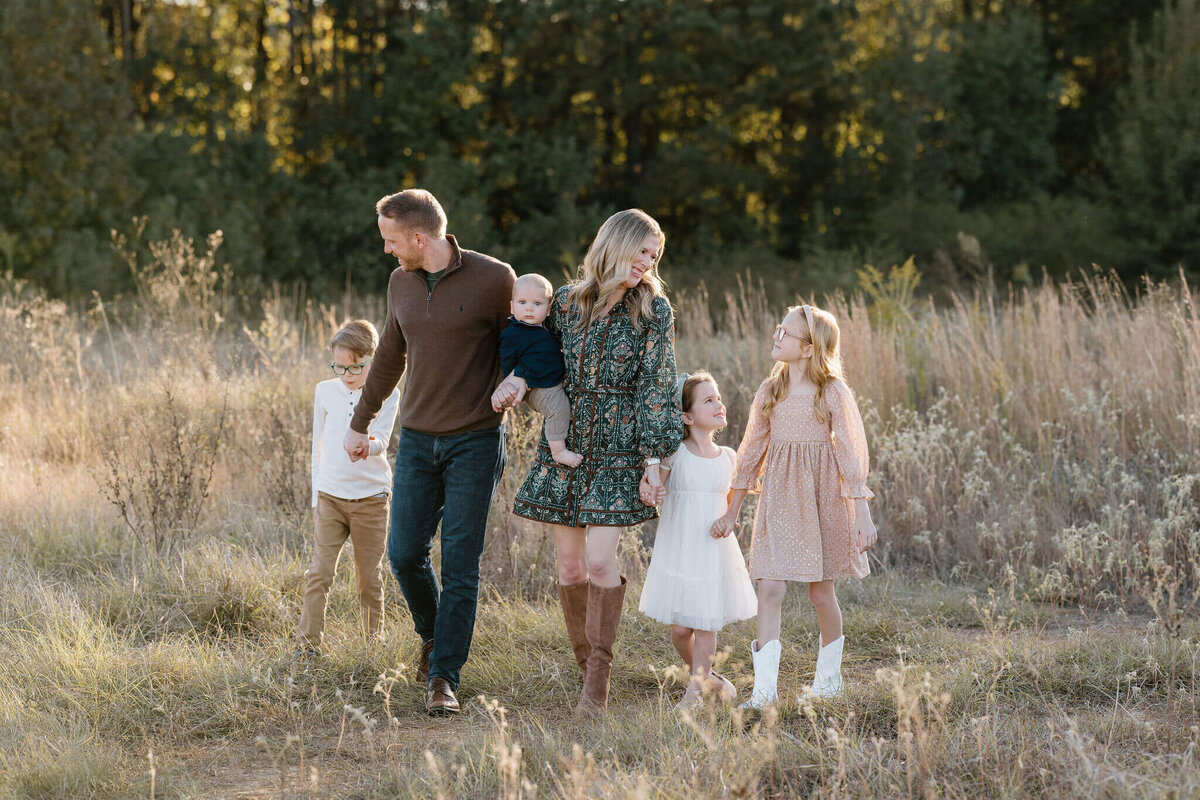 Longview, TX family walking and laughing during family pictures session