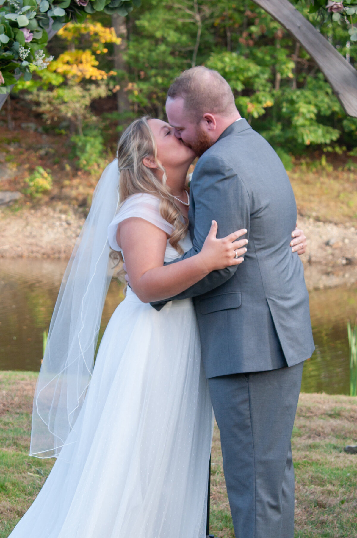 Bride and groom first kiss at wedding ceremony at Fosters Clam Bake in York Maine