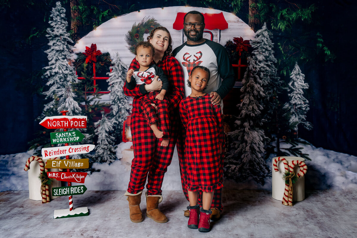Parents pose in holiday jammies for Prescott family photographer Melissa Byrne