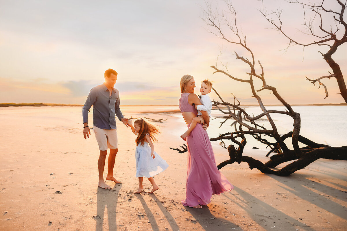Parents play with their children during Family Photos on Folly Beach.