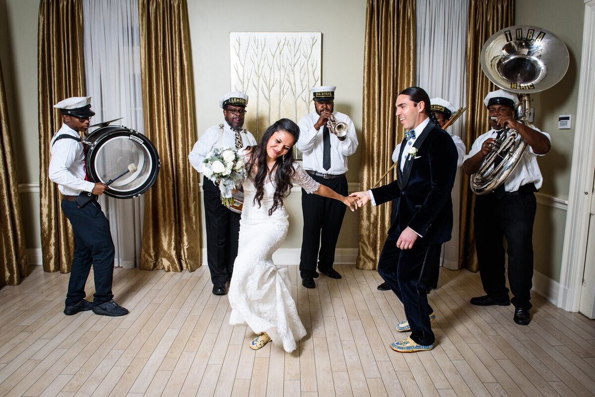 Bride and groom dance with brass band at Southern Oaks wedding