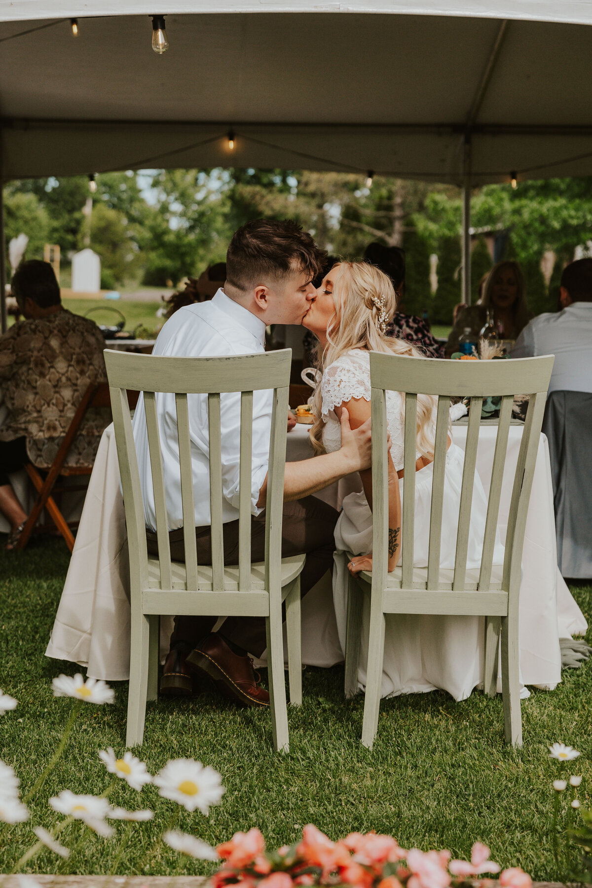couple kissing at their garden wedding