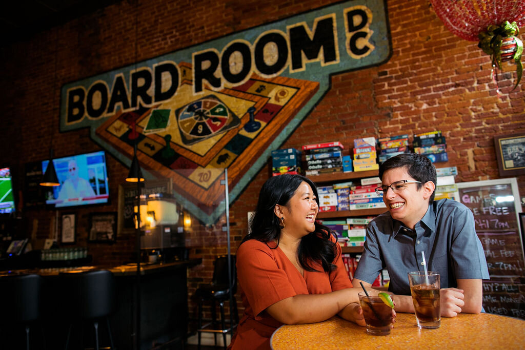 Two people sitting in a unique bar with drinks in front of them
