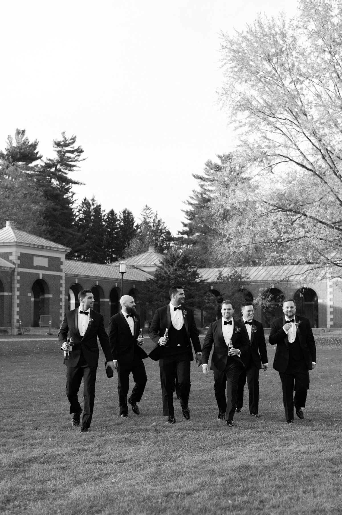Groomsmen walk in the grass outside a Washington DC venue