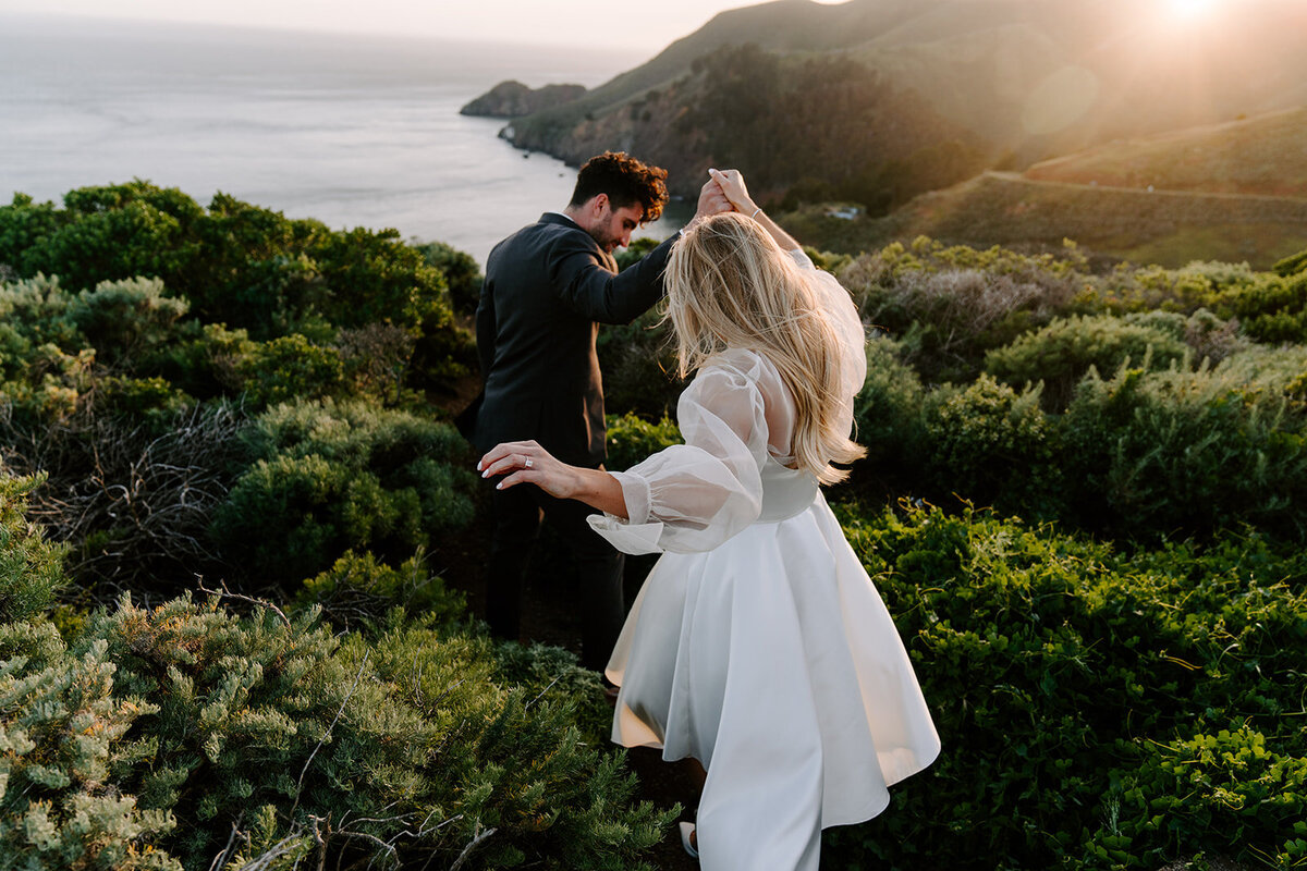couple walking down outdoor stairs before archways