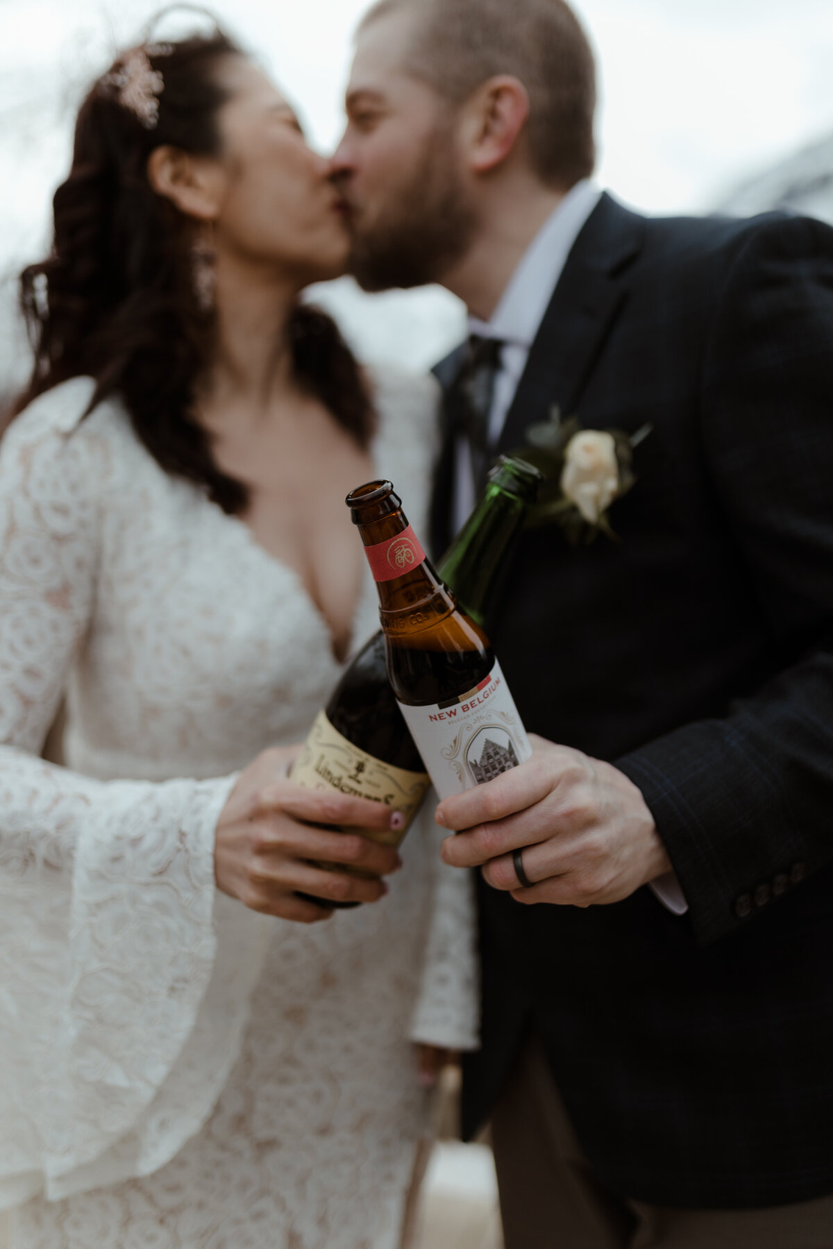 bride and groom holding beer