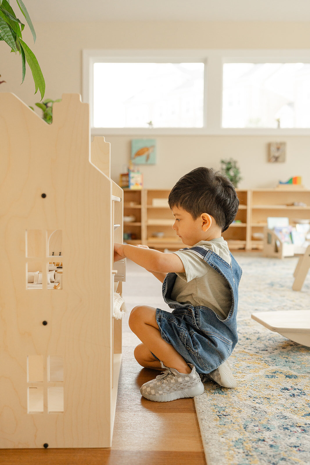 boy playing with a wooden house taken by a Northern Virginia product photographer