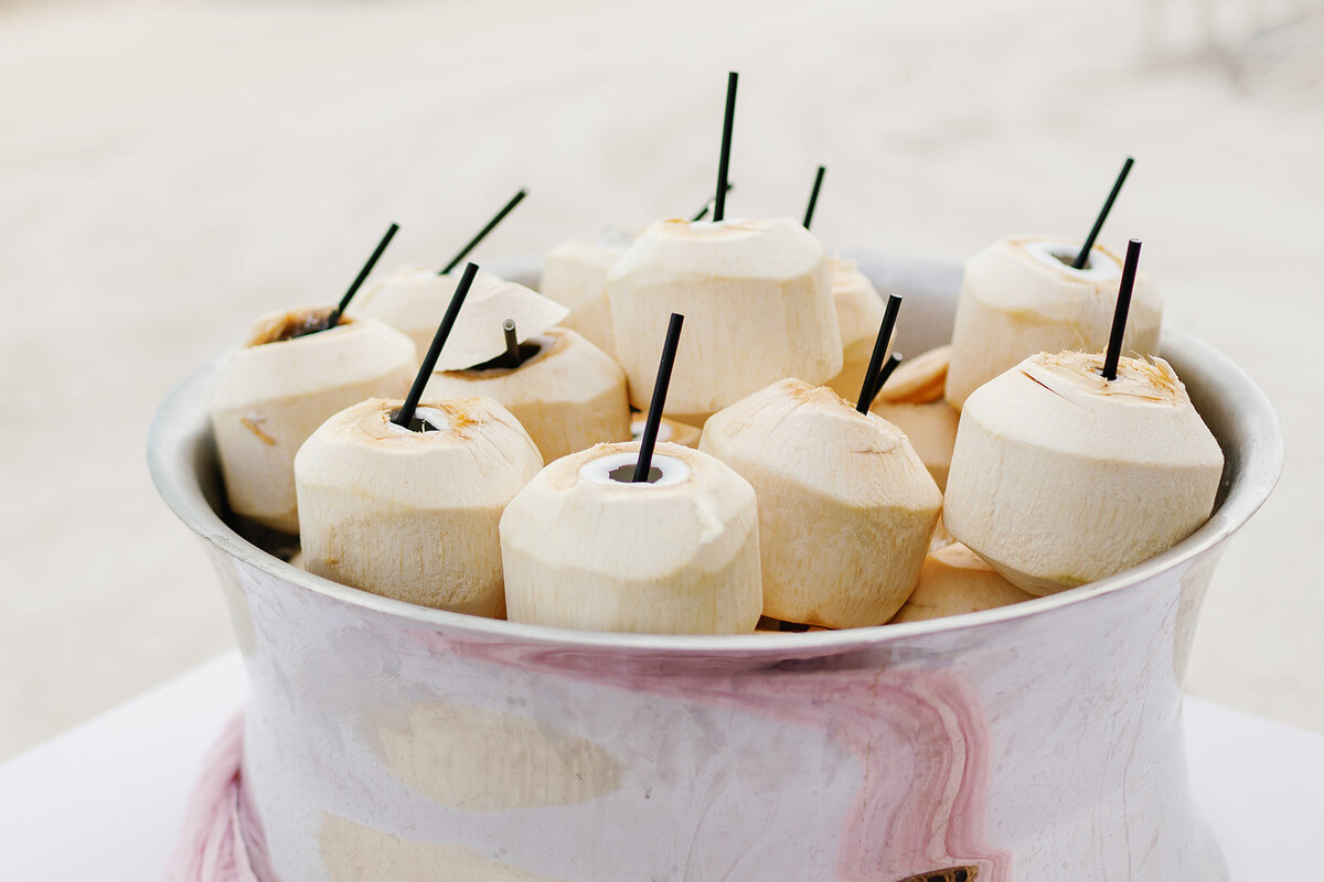 A refreshing tropical drink station featuring fresh coconuts at Brenda & Stephen’s Cheeca Lodge wedding.