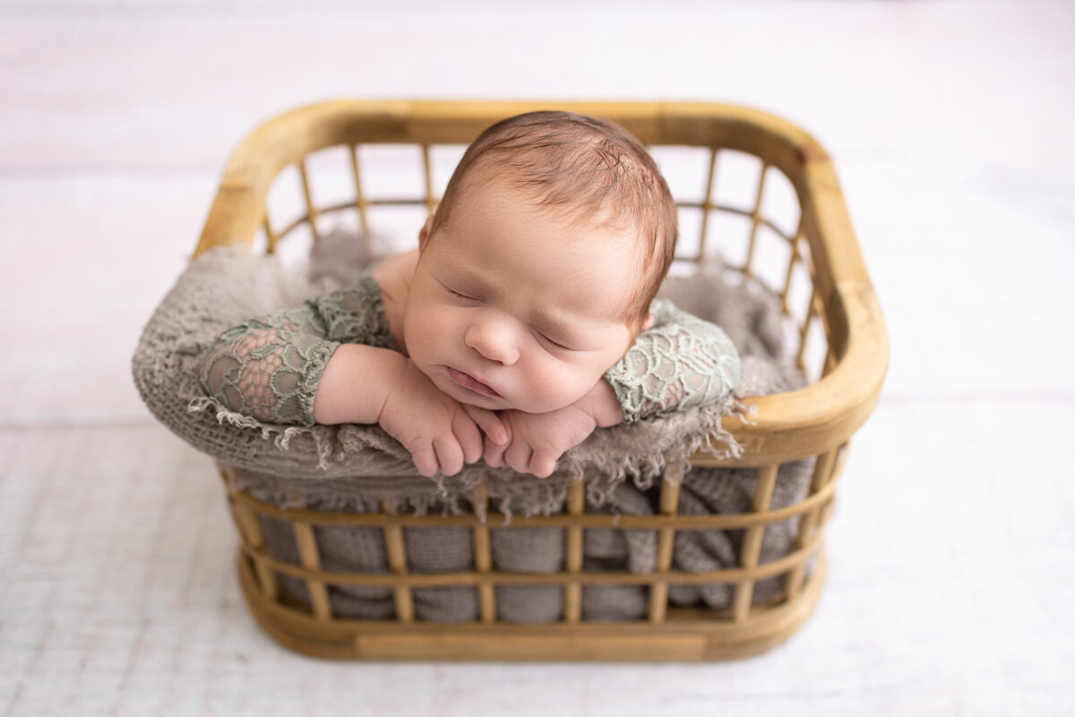 Baby girl in lace outfit posed in a rectangluar prop