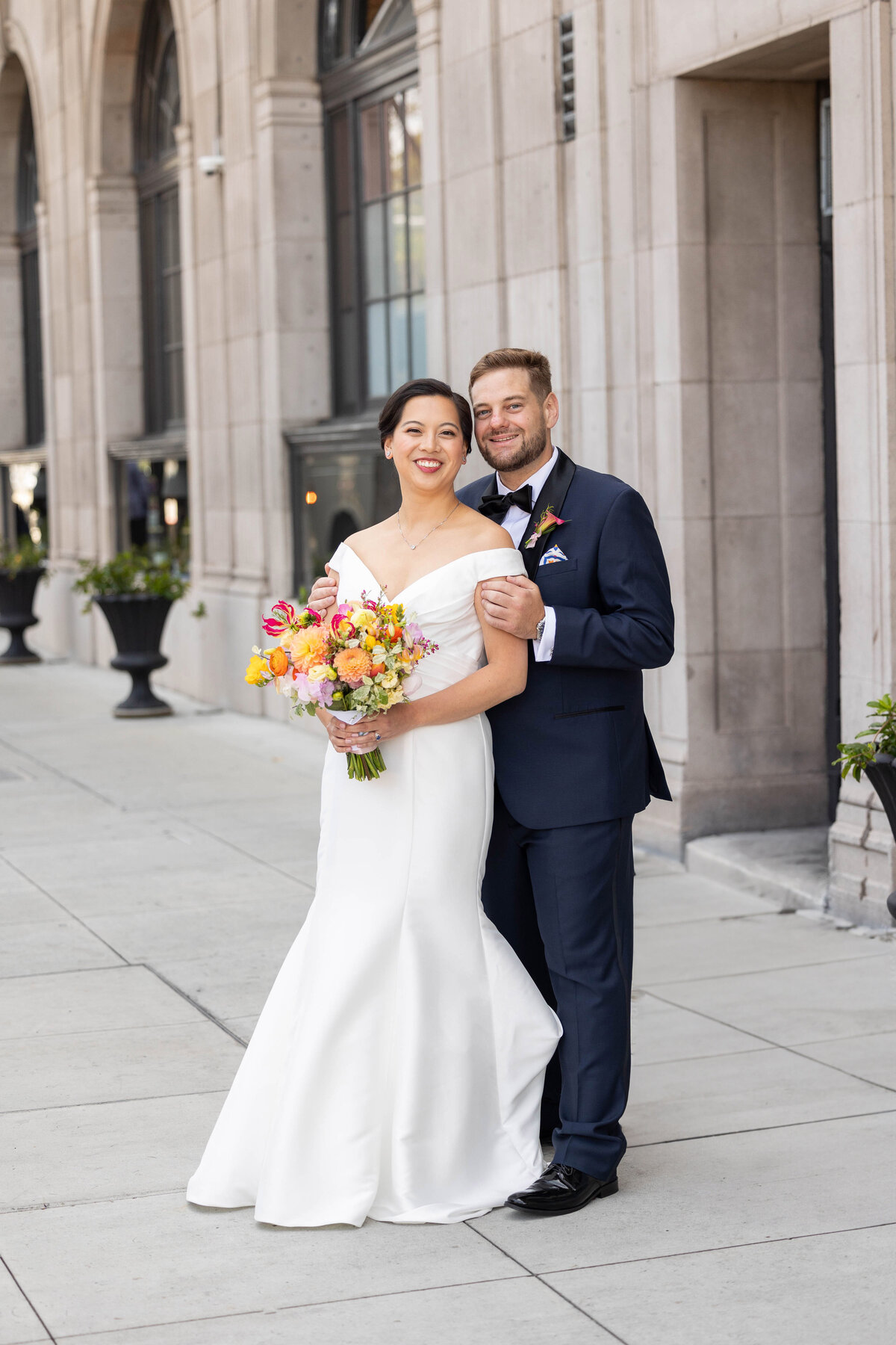 Bride and groom taking photos outside the Culver Hotel