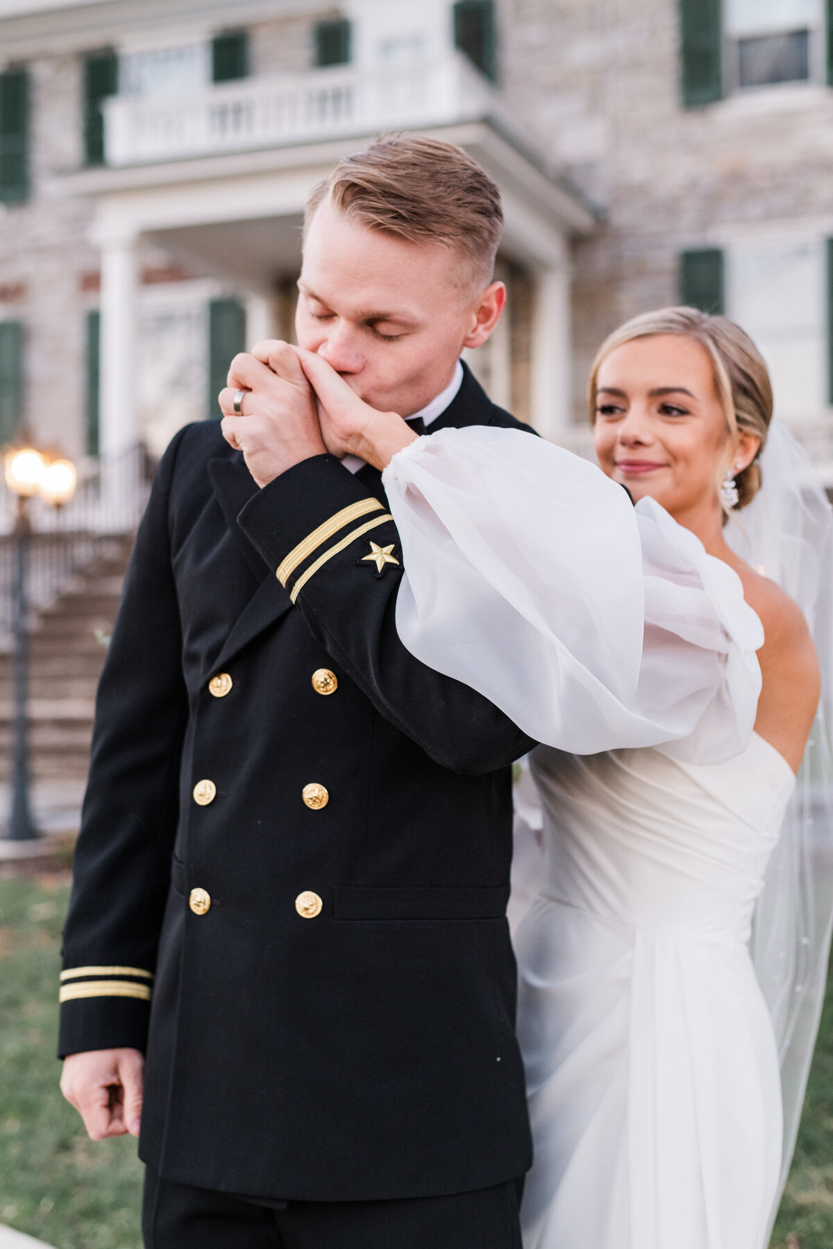 A groom kisses his brides hand