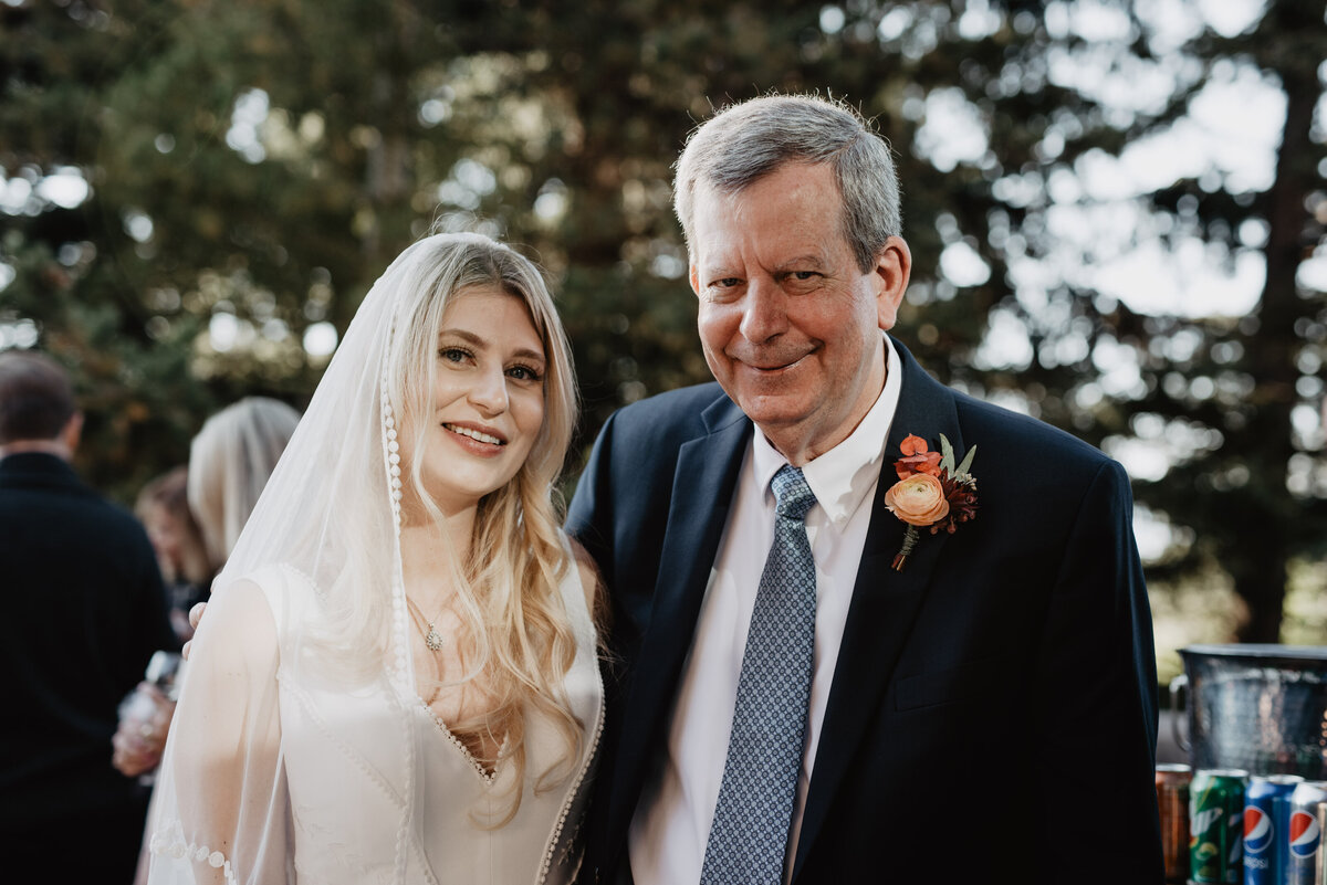 Photographers Jackson Hole capture bride and father smiling together