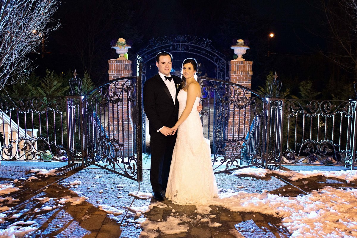 Bride and groom by the gate at The Inn at New Hyde Park