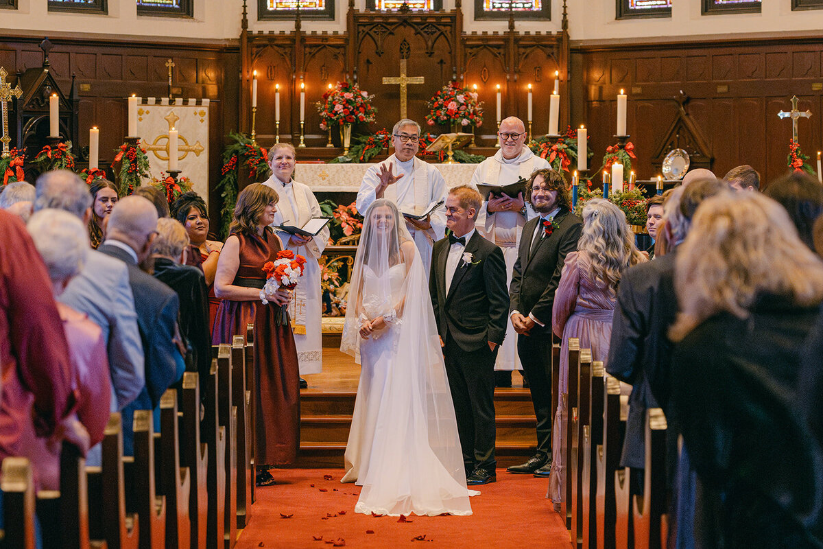 Bride and groom photographed from behind during vow exchange at luxury San Antonio wedding
