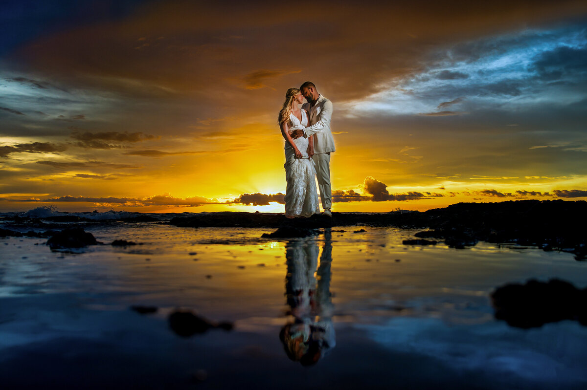 a couple embraces at sunset in Costa Rica