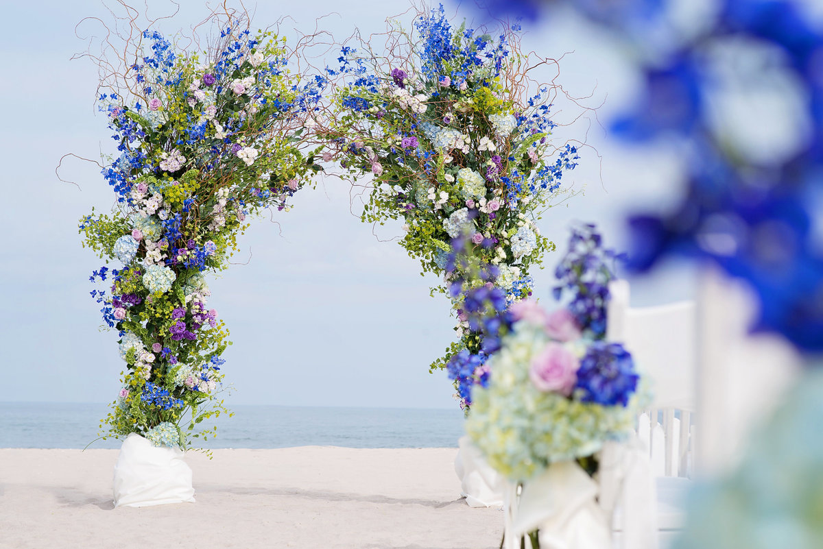 Blue white and pink floral decor for ceremony at Oceanbleu