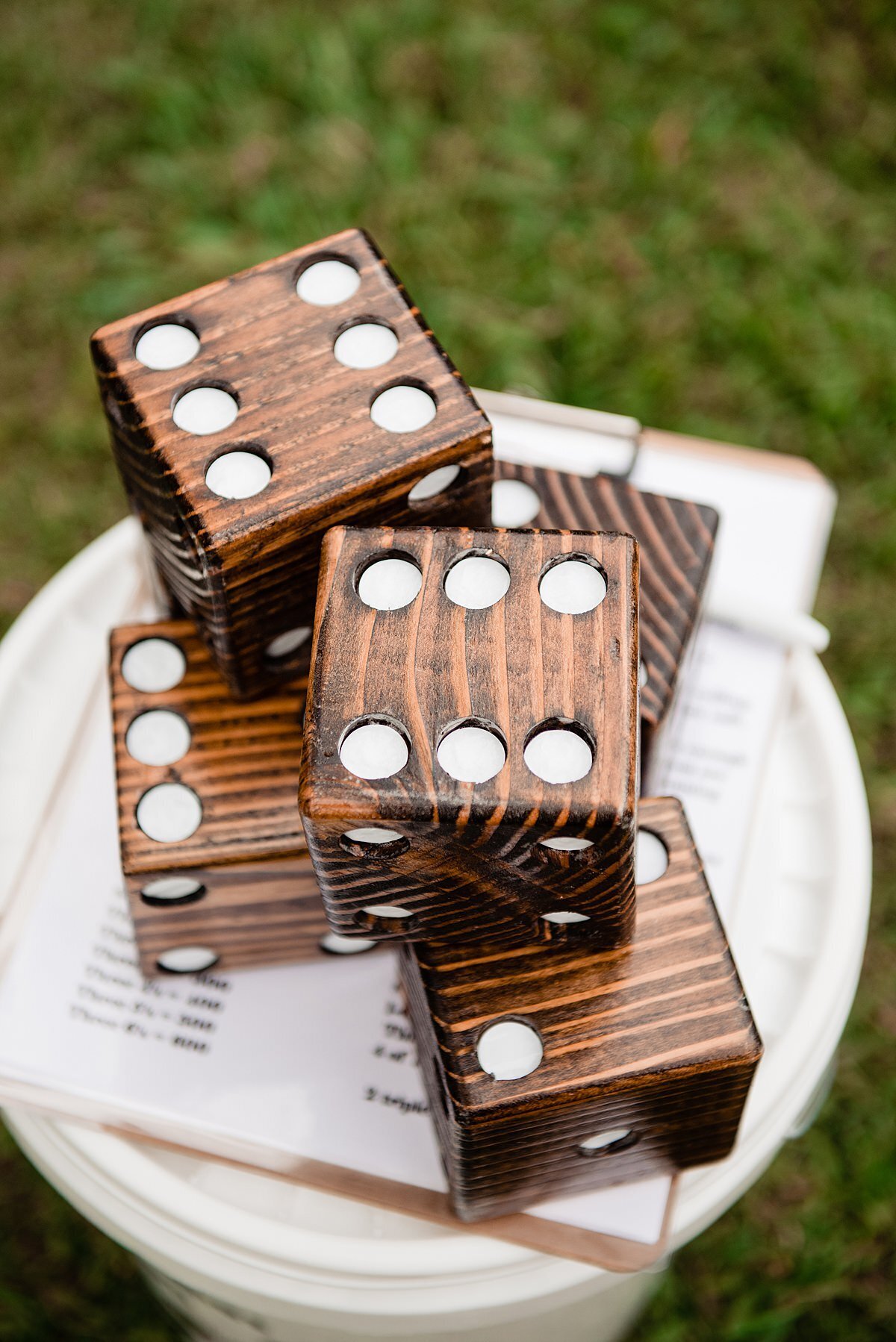 Giant Yahtzee wedding lawn game with large brown wooden dice.