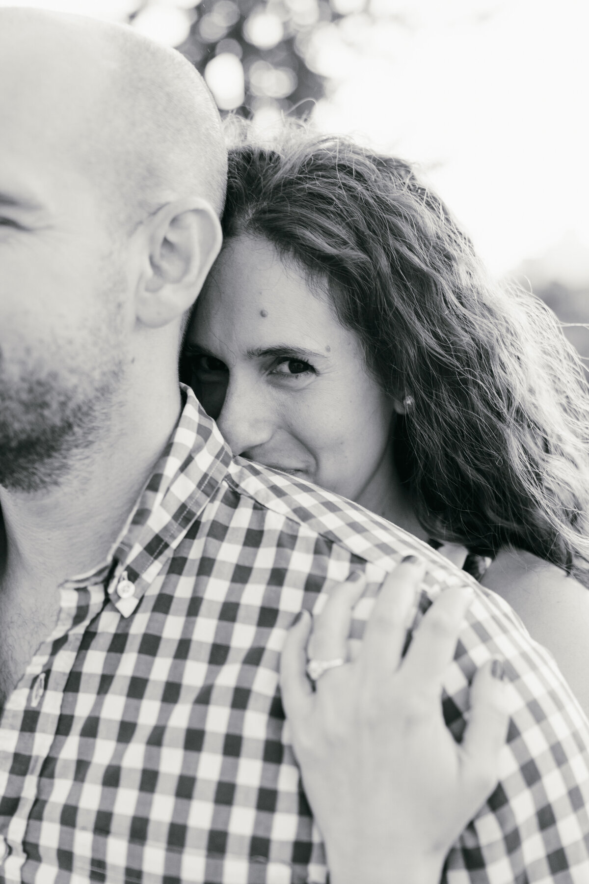 Engaged couple captured in a romantic moment against the stunning urban backdrop of San Francisco during their engagement photoshoot