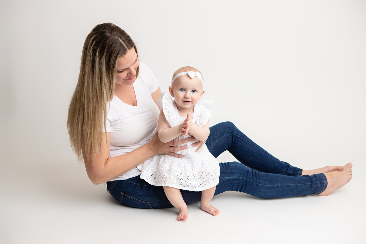 Mommy and daughter on white seamless paper