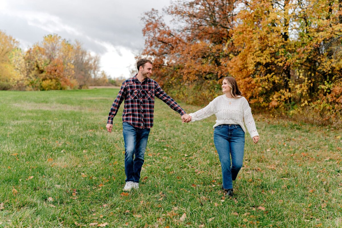 couple-holding-hands-engagement-fall