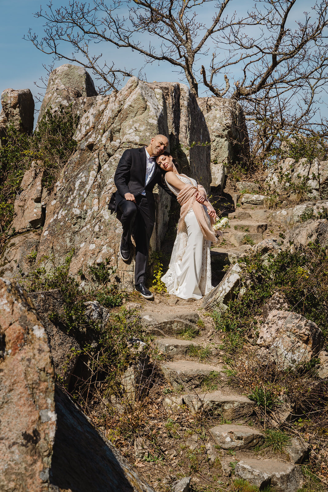 Newlyweds posing on cliffs of Bornholm - the best island for wedding abroad for two