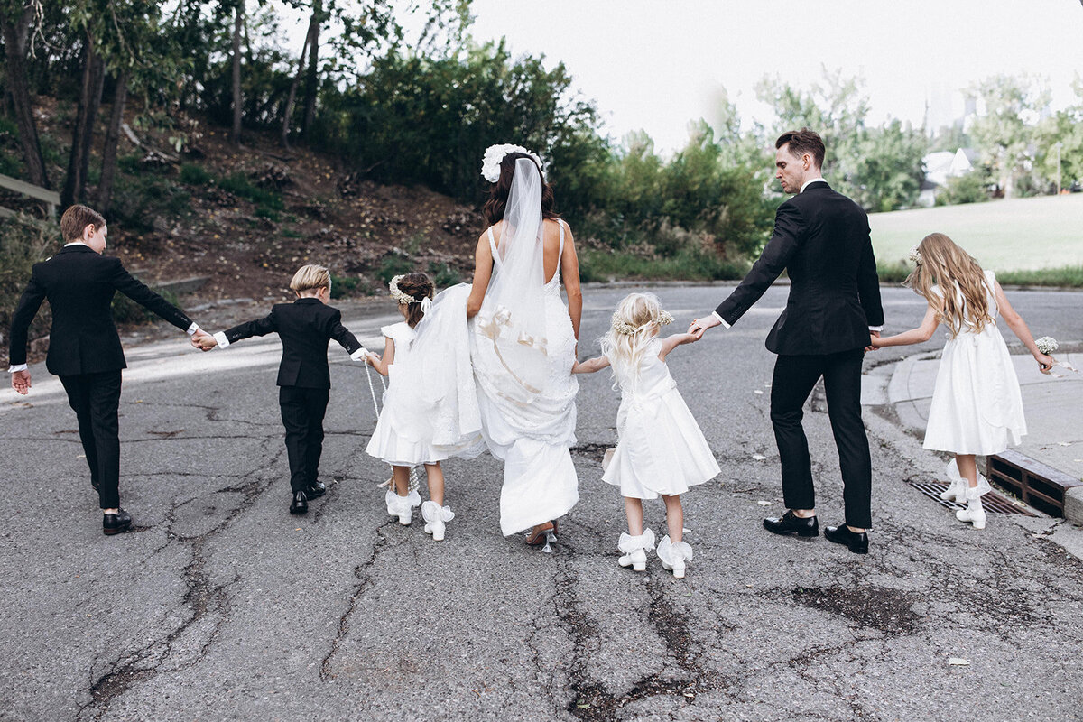Bride and groom walking with flower girls and ring bearers, captured by Bryttanni,  luxury and artistic wedding photographer in Edmonton, Alberta. Featured on the Bronte Bride Vendor Guide.