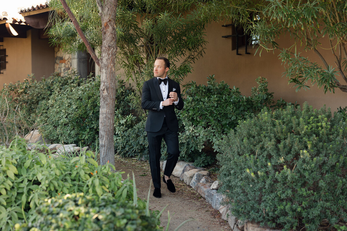 Groom walking for portrait on wedding day