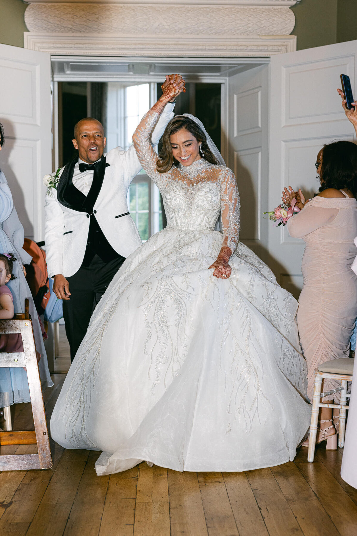 A wedding photo of the married couple entering their reception at Luttrellstown Castle