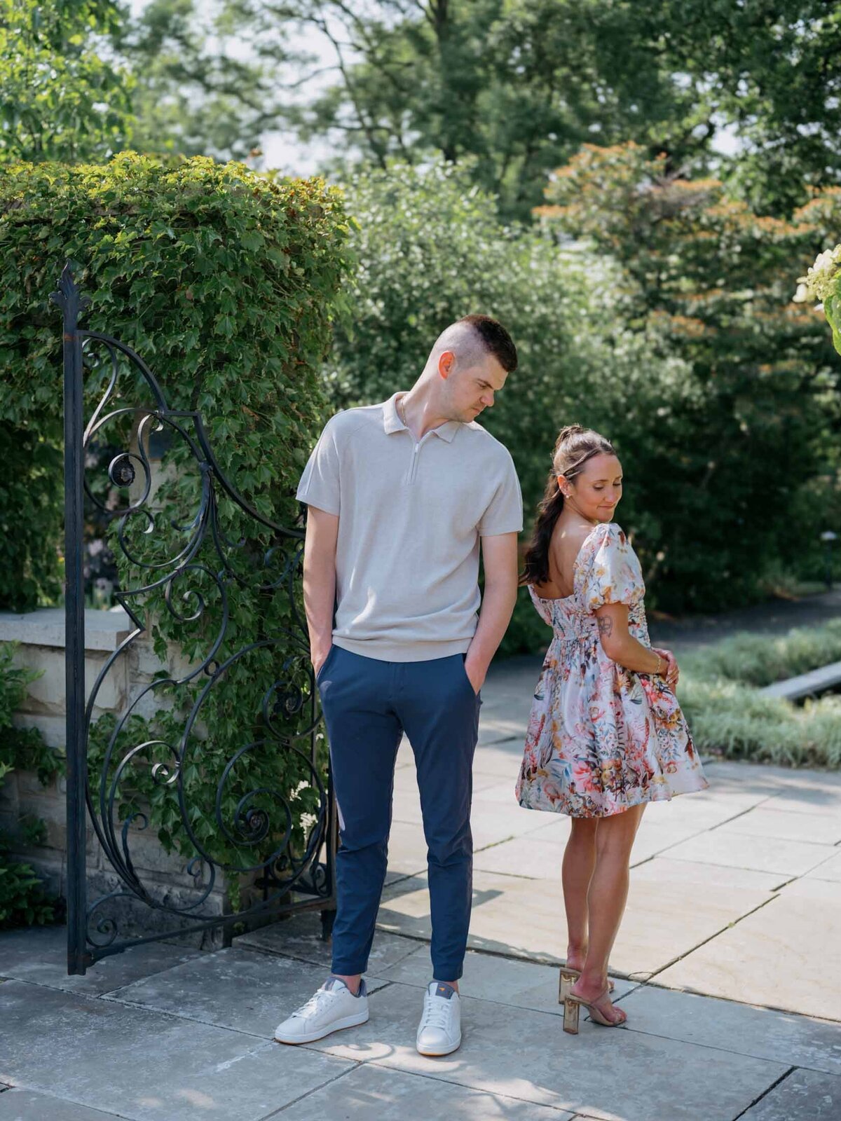 Bride and groom looking towards each other at Cleveland Botanical Gardens for their engagement session.