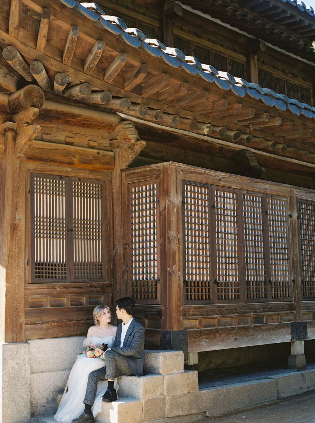 korean couple sitting at palace steps
