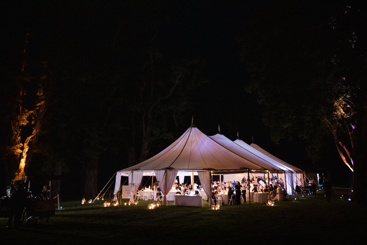 A sailcloth tent at night at a destination wedding in Vermont