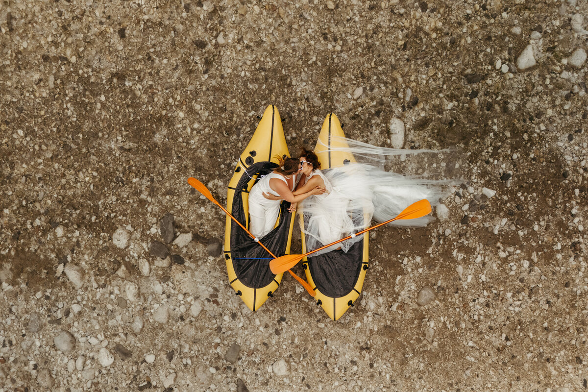 Aerial view of brides in yellow packraft in Soča Valley river elopement