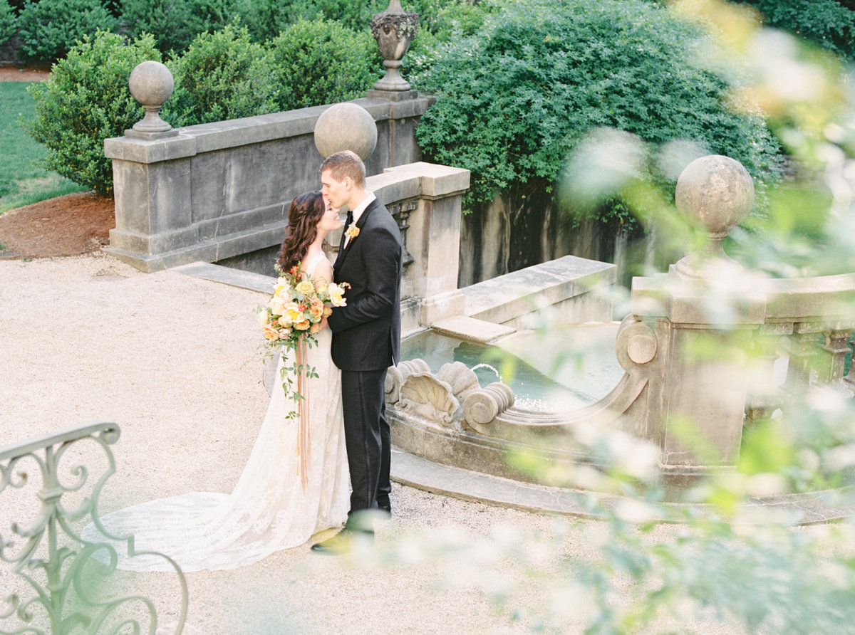 Couple embracing on their wedding day on estate staircase