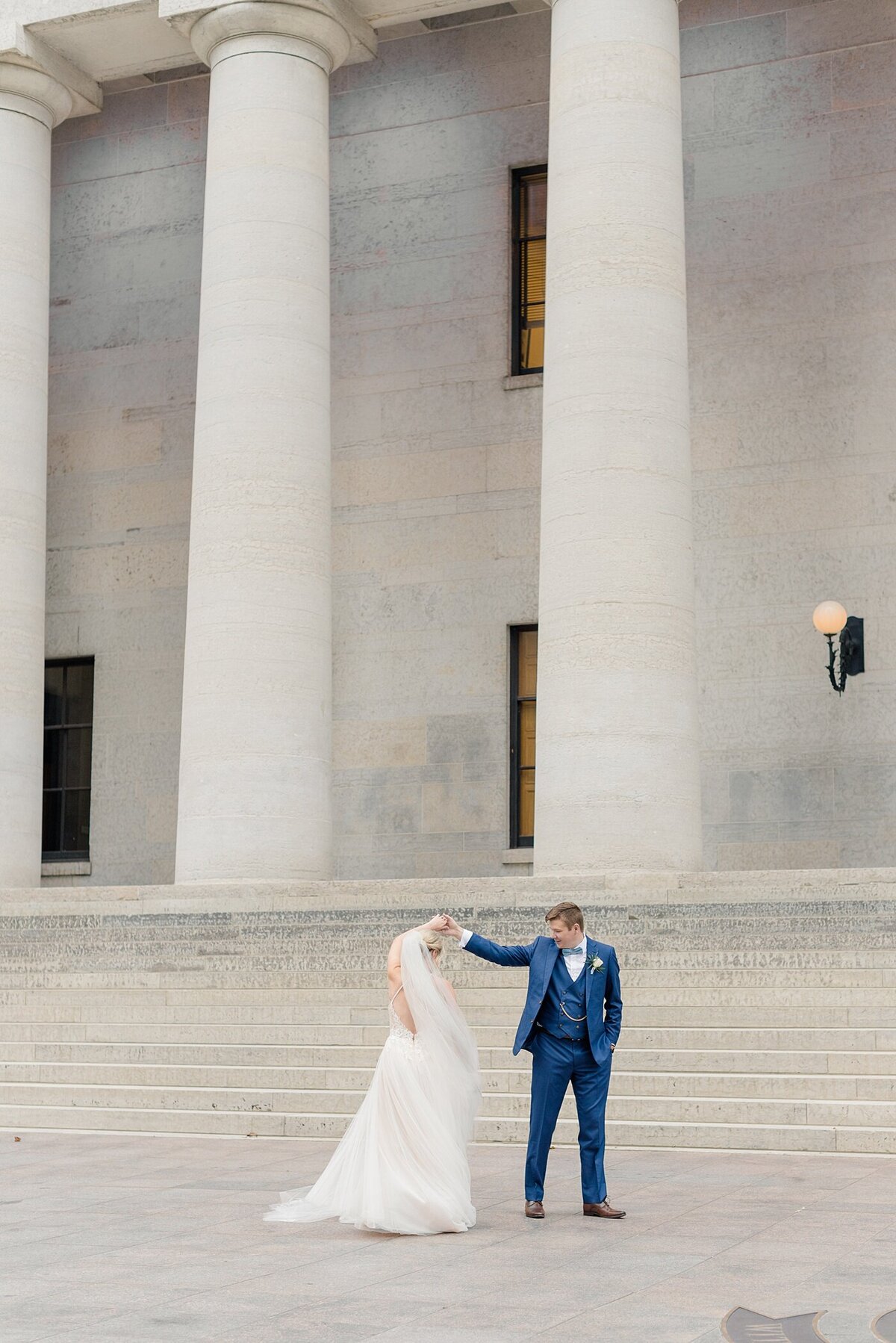 Bride twirls with groom taken by Ohio Wedding Photographer at the Ohio State House