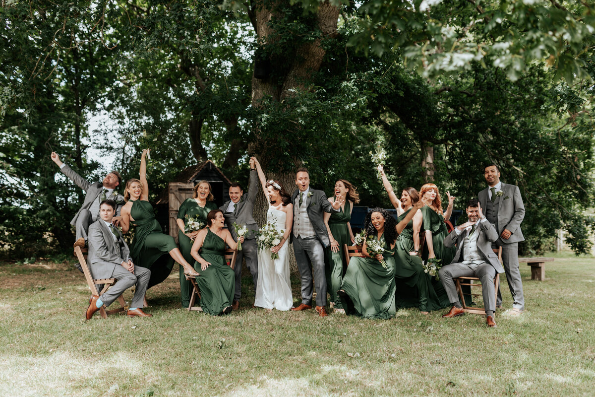 Wedding squad all posing in a dramatic way at Gildings Barn