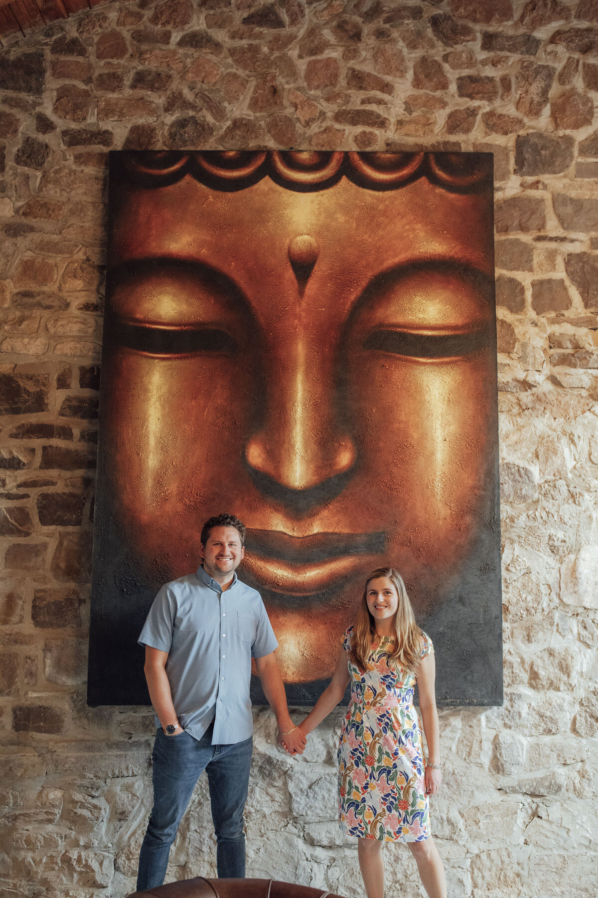 Couple posing by stone wall painting during pre-wedding photo at Logan Inn in New Hope Pennsylvania