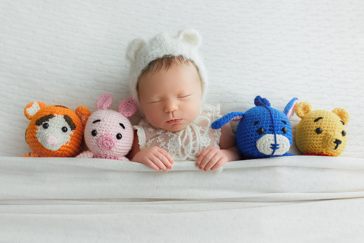 cute baby with winnie the pooh stuffed animals