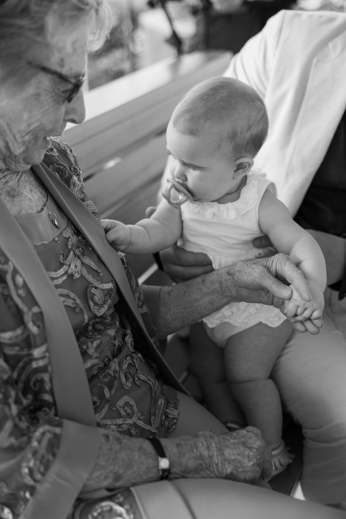 Grandmother holds baby guest during Cancun wedding, photographed by Philly wedding photographer.
