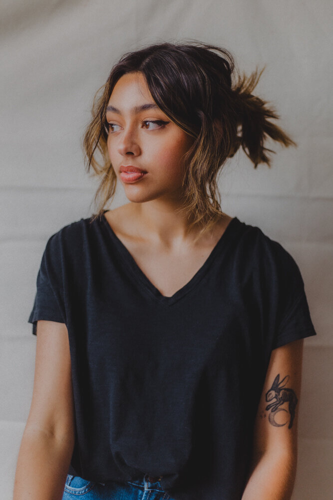 portrait of a girl in front of a blank canvas