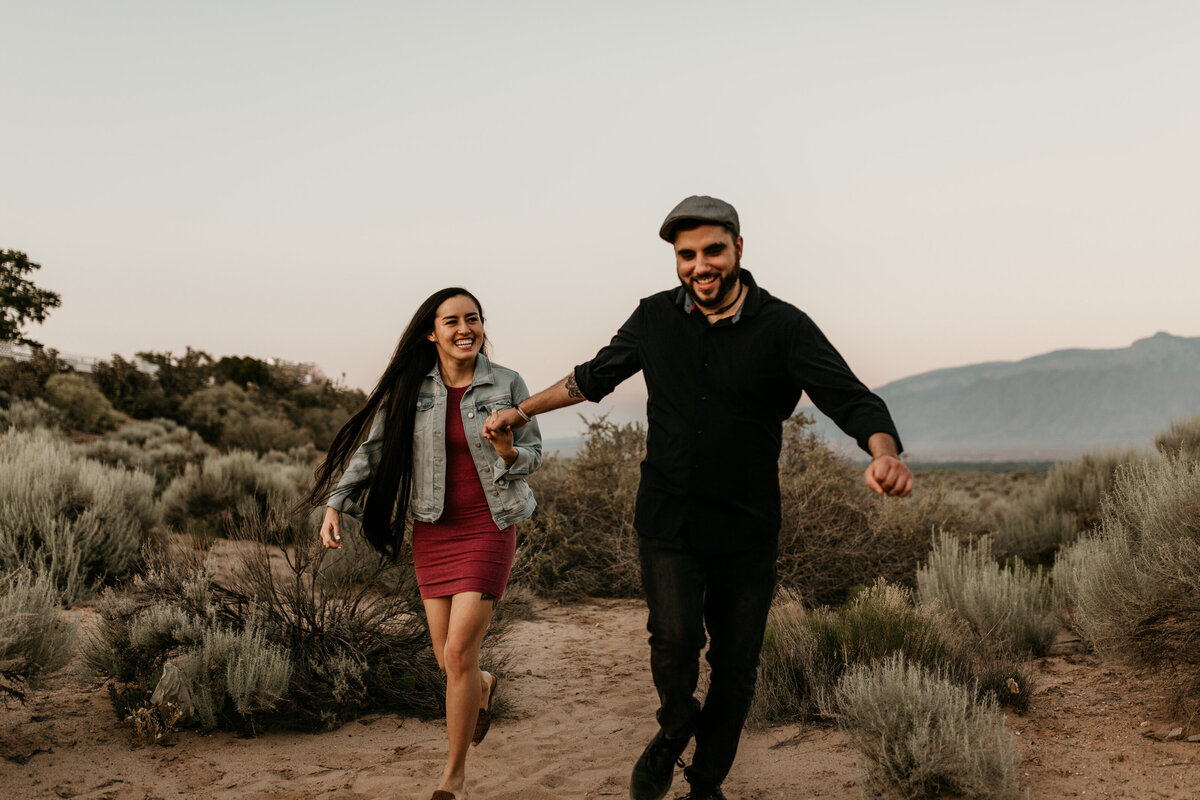 engaged couple running in New Mexico