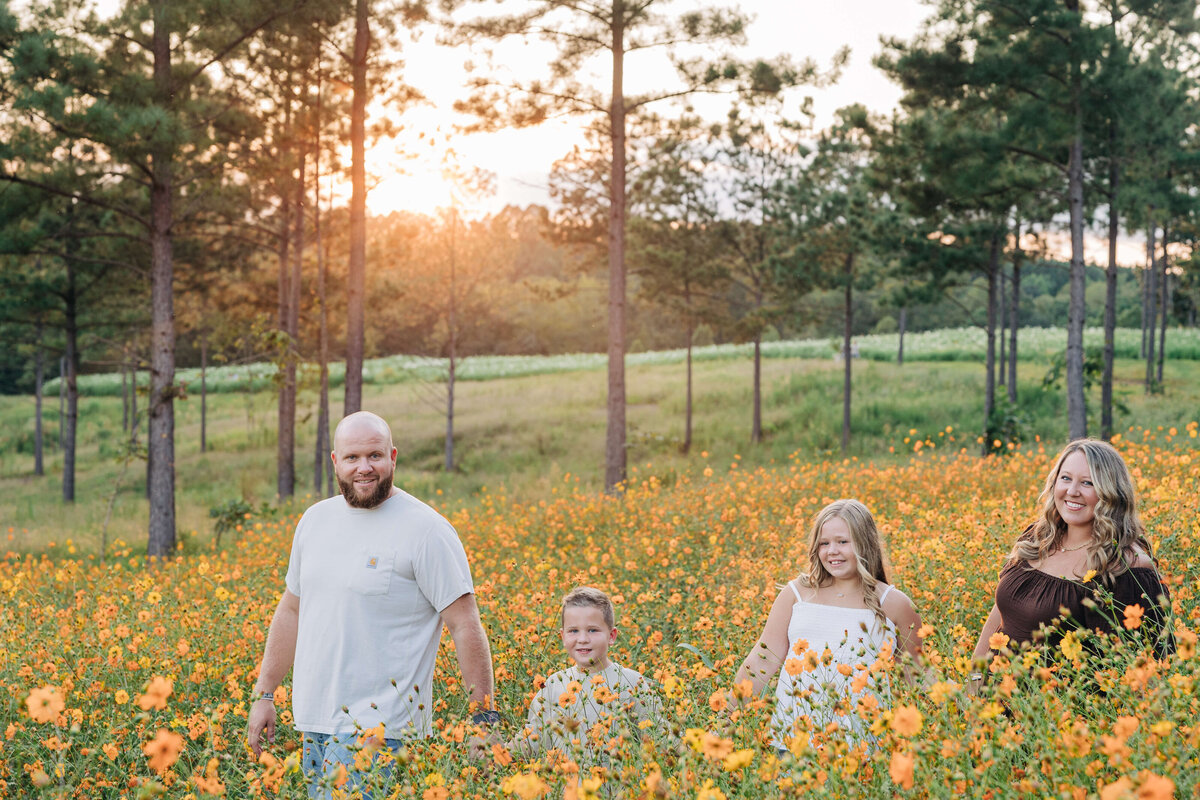 Family-walking-golden-flowers-Dogwood-Farm