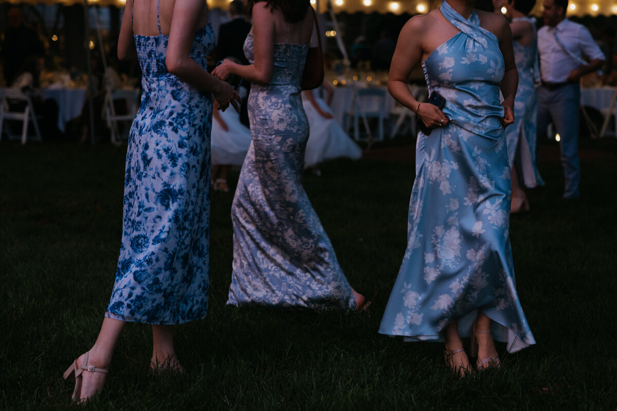 three blue dresses at blue hour during wedding