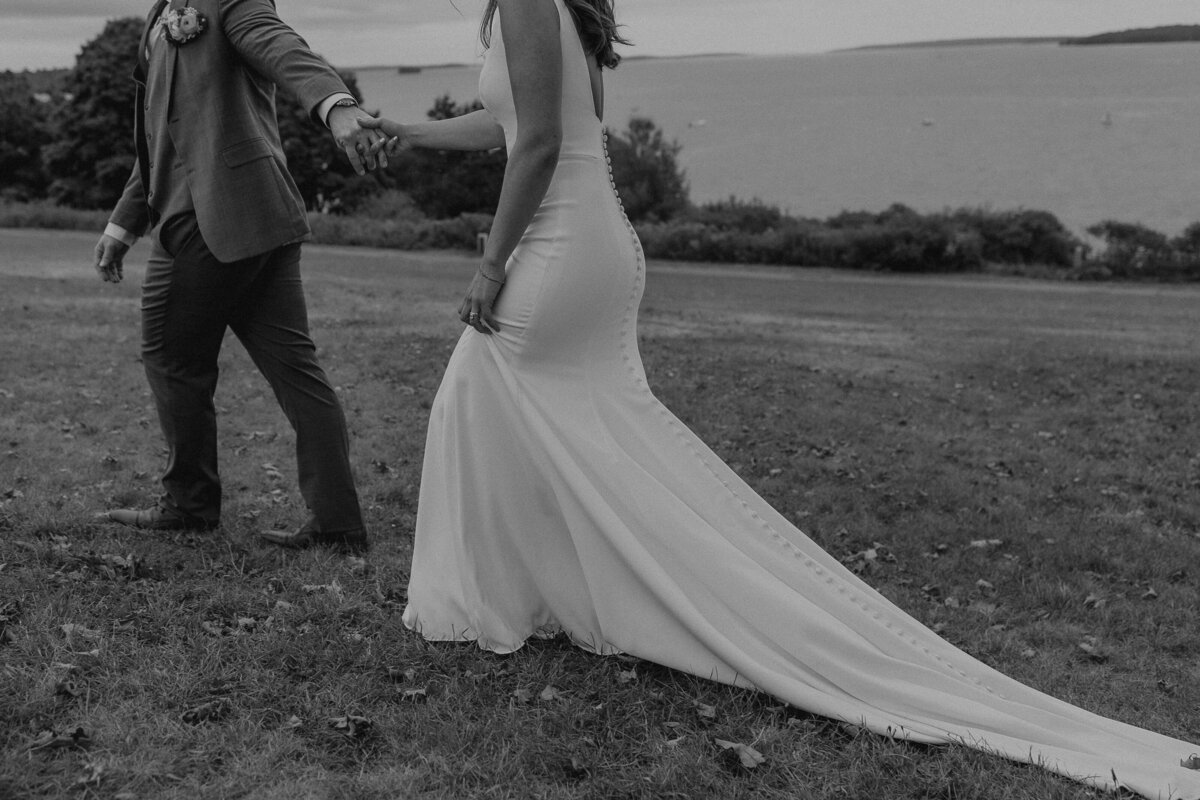 black and white photo of couple walking away outdoors.