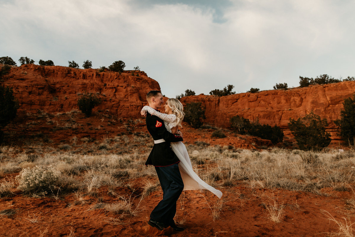 groom spinning wife in red desert