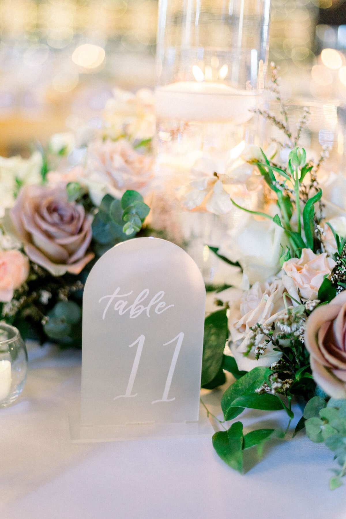 Arched clear frosted table numbers for a timeless wedding available for rent in Denver