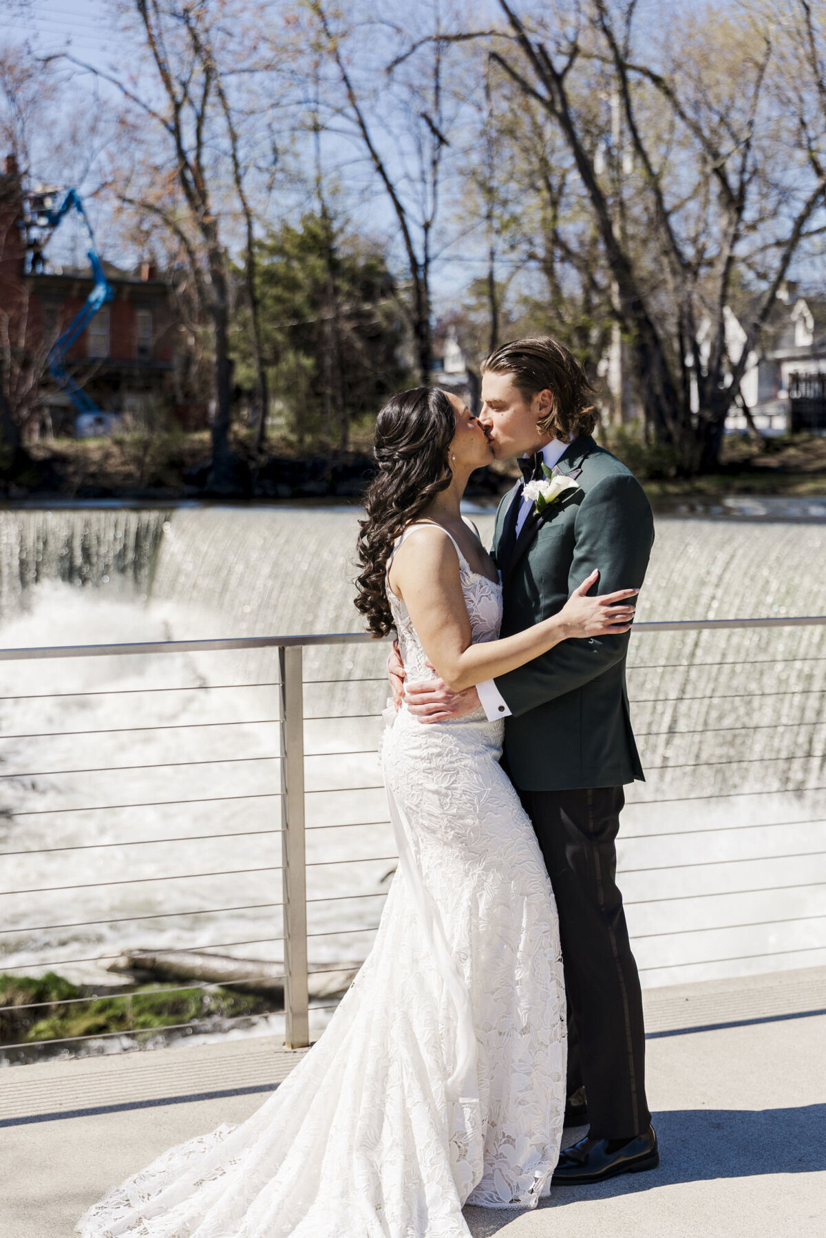 The bride and groom pose by the waterfall by the Roundhouse in Beacon, NY